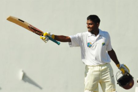 Demerara player Rajendra Chandrika raises his bat to acknowledge his century. He and his captain Vishaul Singh put the Berbice bowlers to the sword yesterday with massive centuries.