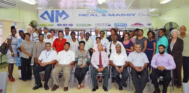 Representatives of the beneficiary organisations pose with directors of the Neal and Massy Group