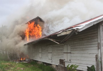 The bond belonging to the Guyana National Newspapers Limited in Lama Avenue on fire  yesterday. (Photo by Arian Browne) 