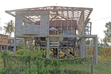 Moving on up: The owners of this property continue to live in their old house as the new one takes shape around it at Buxton, East Coast Demerara. (Photo by Arian Browne)