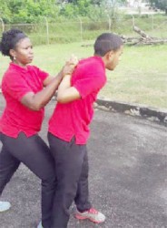 Two CJIA officers practice during the self defence programme