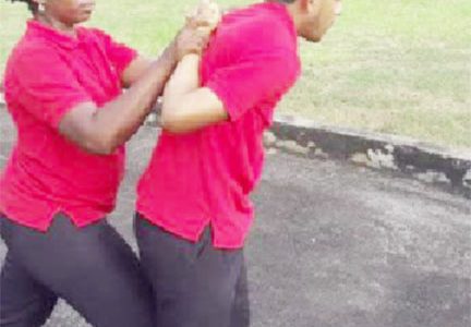Two CJIA officers practice during the self defence programme