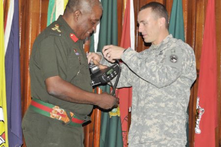 Captain Lawrence presents Brigadier Mark Phillips with one of several hundred communication devices. (US Embassy photo)