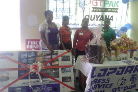 From left are Sales Manager Yonette Jeffers, Nirmala Singh, Projects Coordinator Devina Singh and Sherry Singh with some of the prizes yesterday.
