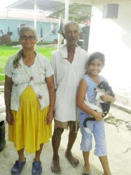 Farmer and cattle herder, Khemraj Mahadeo, along with his wife Basmatie, granddaughter Ashley and pet dog Shadow. 