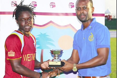 Player-of-the-Series Deandra Dottin receives the Player-of-the-Series trophy from President of the St. Vincent & the Grenadines Cricket Association Kishore Shallow during the third Twenty20 International between West Indies Women and New Zealand Women yesterday at the Arnos Vale Sports Complex. Photo by WICB Media/Ashley Allen.