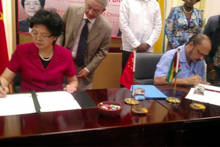 China’s Minister of National Health and Family Planning Li Bin and Health Minister Bheri Ramsaran yesterday signing the Memorandum of Understanding. 