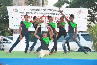 Dancers finish their performance during the Child Protection Week Fun Day at the Botanical Gardens on Saturday. (Photo by Arian Browne) 