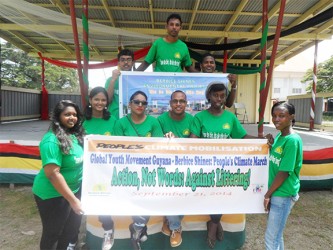 Berbice Shines volunteers posing with their ‘people’s climate’ march banner 