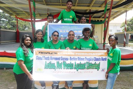 Berbice Shines volunteers posing with their ‘people’s climate’ march banner