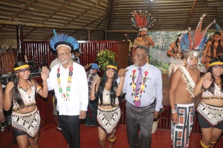 President Donald Ramotar and Prime Minister Samuel Hinds join a cultural group in a dance at the opening of the Amerindian Village and Amerindian Heritage Month at the Sophia Exhibition Site yesterday.  (Photo by Arian Browne)