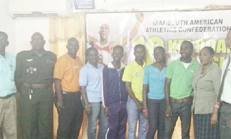 President of the AAG, Aubrey Hutson (extreme right) and members of the association’s executives pose for a photo opportunity with some of the athletes that will compete in the South American 10km Road Classic.
