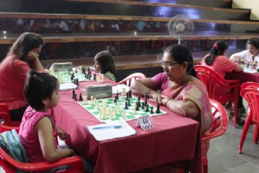 Battle of the Generations! Women’s chess is booming in India. Chess was introduced to a wide cross-section of primary and secondary schools there. Since that time, the number of grandmasters, women grandmasters and other titled players has increased significantly. India captured the bronze medal at the 2014 Tromso Chess Olympiad beating Russia into fourth place, and won the gold medal on the fifth board in the Women’s section of the Olympiad.  This photo was taken at the 2014 National Women Challengers tournament last month and shows a battle of the generations. 