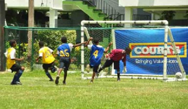 Tucville Primary’s Kevon Marques (no.20) in the process of celebrating after scoring one of his three goals during his teams’ huge win over Thomas Moore Primary 