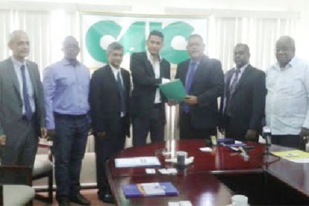 President of the CAIC Ramesh Dookhoo (third from right) shaking hands with the Vice-President of CCI GUYANE Alex Madeleine after the MOU signing. Also in the photo are from left: French Ambassador to Guyana Michel Prom, Manager of Nord Quest Transports Victor Bantifo, CAIC Vice President Anilkumar Padarath, Chairman of the PSC Ramesh Persaud and Head of the Guyana Manufacturing and Services Association, Clinton Williams. 