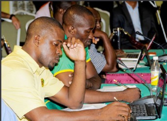 Guyana Franchise representatives Esuan Crandon (Head Coach) and Rayon Griffith (Chairman of Selectors) study which players they will choose in the second round of the Draft yesterday. WICB Media Photo/Randy Brooks 