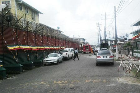 Fire fighters and policemen outside the Camp Street prison minutes after arriving to deal with the report.
