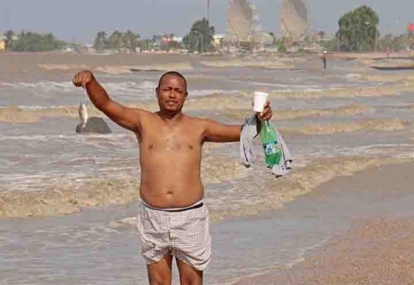 For dinner? A man showing off his catch at the Kingston seawall on Monday.