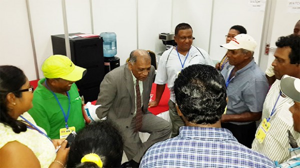 Suriname agri talks: Agriculture Minister Dr Leslie Ramsammy (centre) meeting with a group of Guyanese farmers who participated in the three workshops during the Caribbean Week of Agriculture being hosted in Suriname. The majority of the farmers attended the Value Chain Development workshop aimed at growing the family farms. 