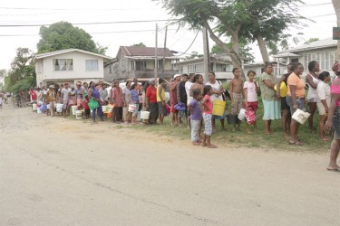 Lining up for flood supplies relief from Food for the Poor