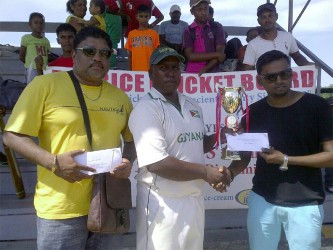 Shabeer Baksh, Assistant Treasurer, BCB hands over winning trophy and cash to captain, Jaipaul Heeralall, of winning team in the presence of Anil Beharry, first vice-president of the BCB. 