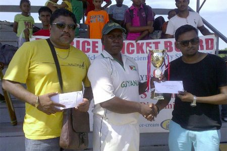 Shabeer Baksh, Assistant Treasurer, BCB hands over winning trophy and cash to captain, Jaipaul Heeralall, of winning team in the presence of Anil Beharry, first vice-president of the BCB.
