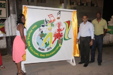 Minister of Culture, Youth and Sport Frank Anthony (second, right) unveils the logo for Mashramani 2015 along with theme competition winner Ariel Gittens (left) and Chairman of the Mashramani Committee Lennox Canterbury. (Photo by Arian Browne)