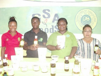 Members of the Guyana School of Agriculture (GSA) proudly display the institute’s products: (from left to right) Amy Price, Akeem Williams, Stacia Nelson-McDonald, and Kay Rodrigues