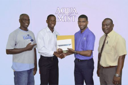 Youth Cricketer Shimron Hetmyer (second left) receives his sponsorship package from Errol Nelson, Banks DIH Limited Brand Manager (Water) while his father Gladston Hetmyer and Communications Manager Troy Peters look on.