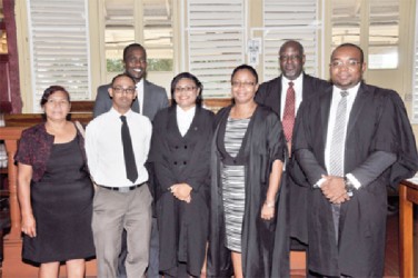 Photo shows Shantel Scott (fourth from right) with Justice Roxane George-Wiltshire  (third from right) and others at her admission ceremony. 