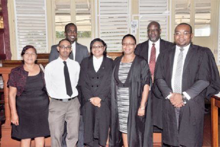 Photo shows Shantel Scott (fourth from right) with Justice Roxane George-Wiltshire  (third from right) and others at her admission ceremony.
