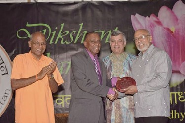 President Donald Ramotar (right) presents the Master of Education Award to Julius Nathoo. Also in photo are Principal, Saraswati Vidya Niketan, Swami Aksharananda (left)  and Dr. Dhanpaul Narine. (GINA photo)