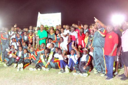 The GDF track and field outfit posing with the winner’s Inter Services Annual Athletic Championship Trophy. (Orlando Charles photo)