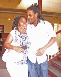 A smiling Jermaine Carter and his wife hugging each other as they left the Georgetown Magistrates’ Courts complex yesterday after he was freed of a drug trafficking charge. (Photo by Arian Browne) 