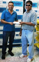 WJ Enterprise’s Heralall Narine (left), presents the sponsorship cheque to Surendra Nauth of the GFSCA.