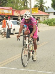 Marlon ‘Fishy’ Williams crossing the finish line to win his second consecutive stage of the Ride for Life five-stage road race yesterday in Essequibo. (Orlando Charles photo)