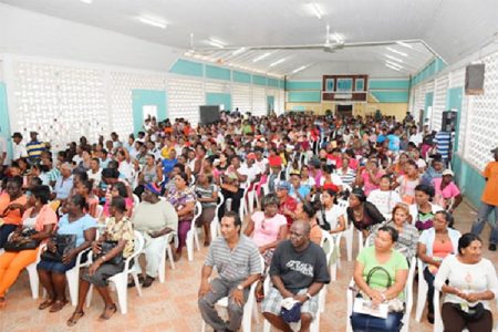 Parents of students of Berbice High, Vryman’s Erven Secondary, All Saints Primary, St. Aloysius Primary and Smythfield Nursery at the distribution exercise at the Berbice High School (GINA photo)