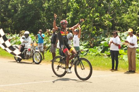  Robin Persaud celebrates as he crosses the finish line in the final stage of the eighth annual ‘Ride for Life’ five-stage event yesterday. (Orlando Charles photo)
