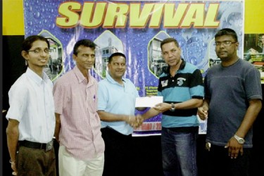 Assistant Manager of Survival Travel Agency, Mark DeFreitas (second right), presents the tickets to Rohan Booj-Raj of the GFSCA in the presence of other representatives of the two bodies 