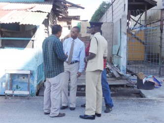 Mark Benschop (second from left) with Paul James (backing camera) and an on site police officer discussing the situation yesterday. (Photo provided by Mark Benschop)           