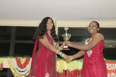 A final year Economics major (at left) receiving the first prize trophy for the winning Rangoli. (Photo by Arian Browne)