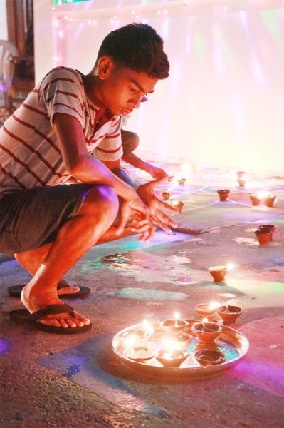 Pensive: This young Kitty resident gazing thoughtfully at his lit diyas in Kitty last night. (Photo by Arian Browne) 
