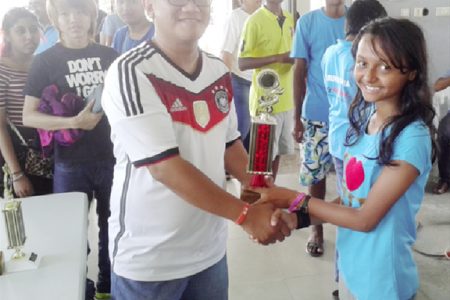 Sheriffa Ali receives her trophy after winning the blitz chess tournament in Suriname.
