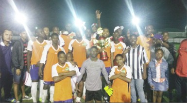 Players and members of the Fruta Conquerors management staff posing with their championship trophy after downing Pele in their final league fixture.