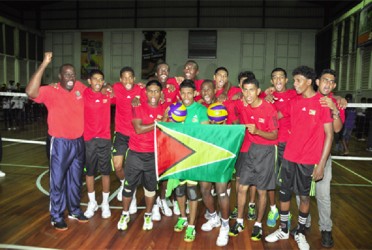 The victorious volleyball team posing with coach, Levi Nedd following the four-set victory versus Suriname last night. 