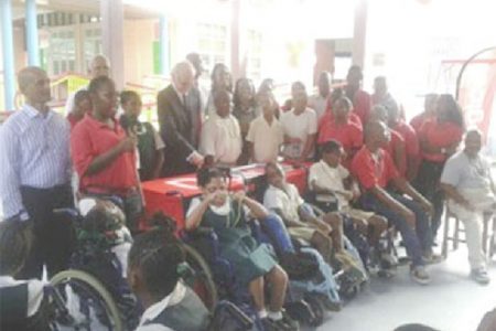 Representatives of Digicel and students of Ptolemy Reid Rehabilitation Centre at the ceremony yesterday. 