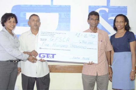 Ramchand Ragbeer, President of the Guyana Floodlight Softball Cricket Association,  (second from left)  receives the  sponsorship cheque from GT&T Marketing Officer Nicola Duggan (extreme left)  in the presence of GT&T’s Marketing Officer Margaret Washington and GFSCA’s Daram Persaud.