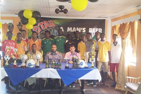 GFA President Vernon Burnette (sitting centre) along with GFA Vice President of Competitions Frank Parris (sitting left) and Stag Beer Brand Manager John Maikoo (sitting right) is flanked by members of the competing clubs during the launch of the GFA Stag Beer Futsal Championship yesterday.
