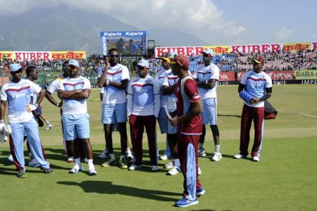 Dwayne Bravo captain of West Indies walks back with his team after the toss before the start of the 4th One Day International, ODI, between India and The West Indies held at the HPCA Stadium, Dharamsala, India on the 17th October 2014 Photo by: Pal Pillai/ Sportzpics / BCCI