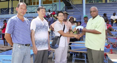 Baishanlin’s Forestry Development Department Director, Eddie Wang (third from left) handing over the cheque to Horace James. 